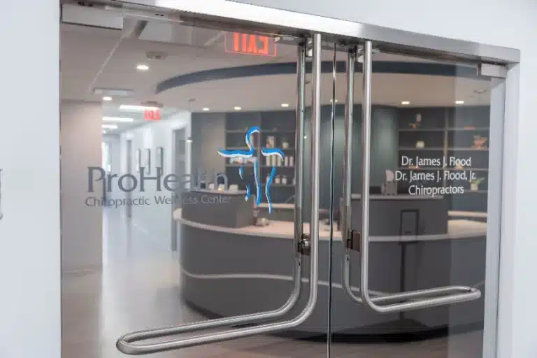 Glass entrance doors with the ProHealth logo and chiropractors' names at ProHealth Chiropractic Rockville clinic