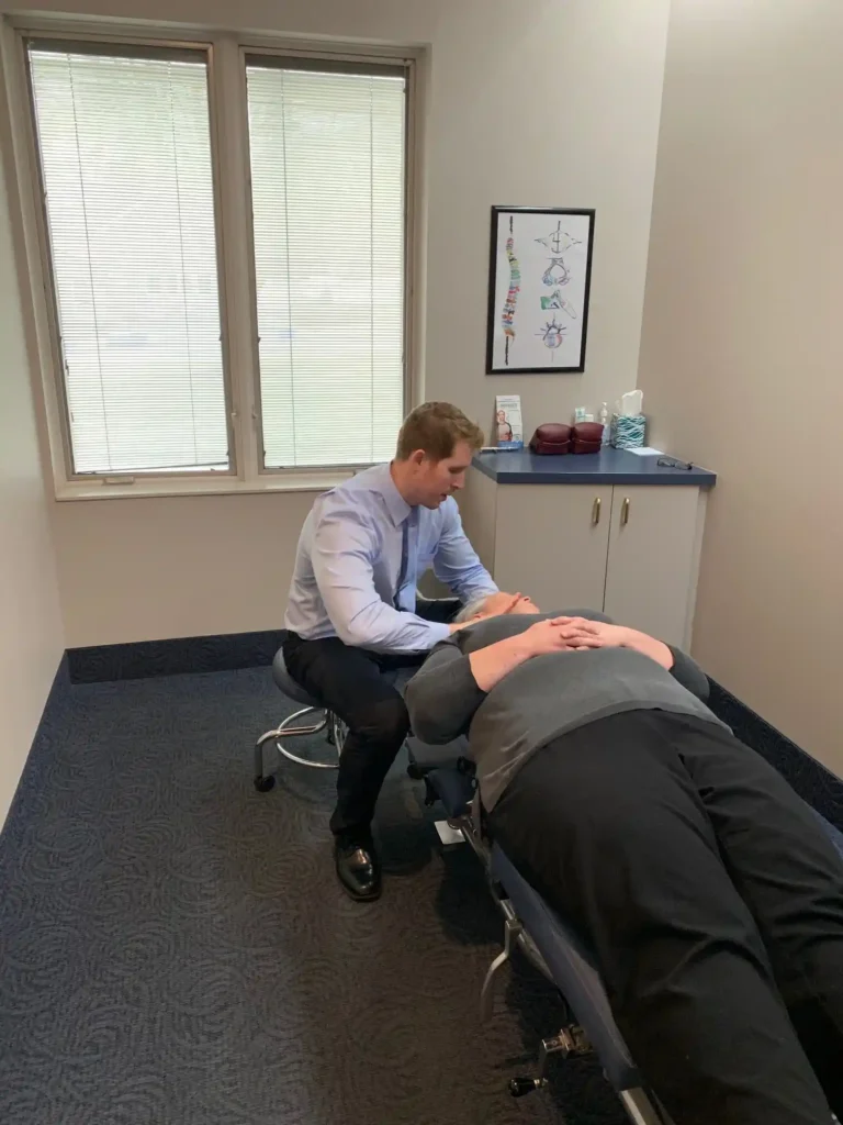 Woman with lower back and hip pain highlighted in red at ProHealth Chiropractic Rockville clinic