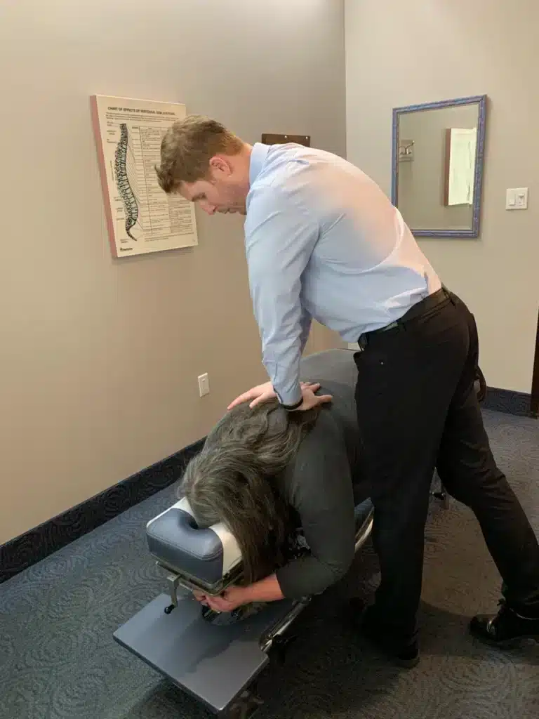 Chiropractor performing a prone spinal adjustment on a patient using a drop table at ProHealth Chiropractic Rockville clinic