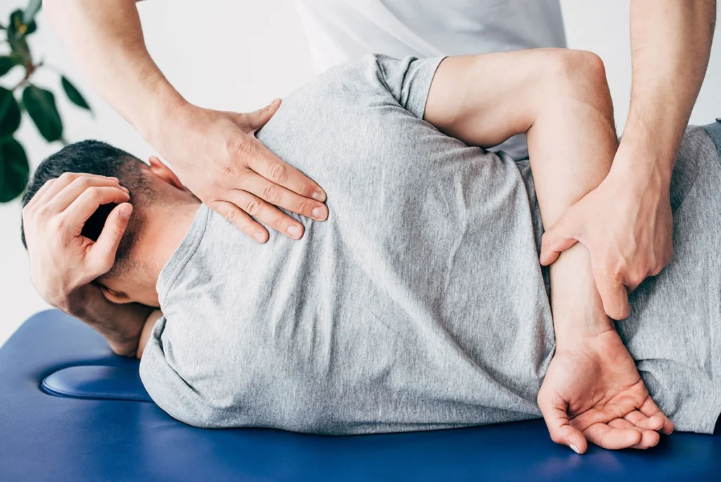 Chiropractor performing a side-lying spinal rotation adjustment on a patient at ProHealth Chiropractic Rockville clinic