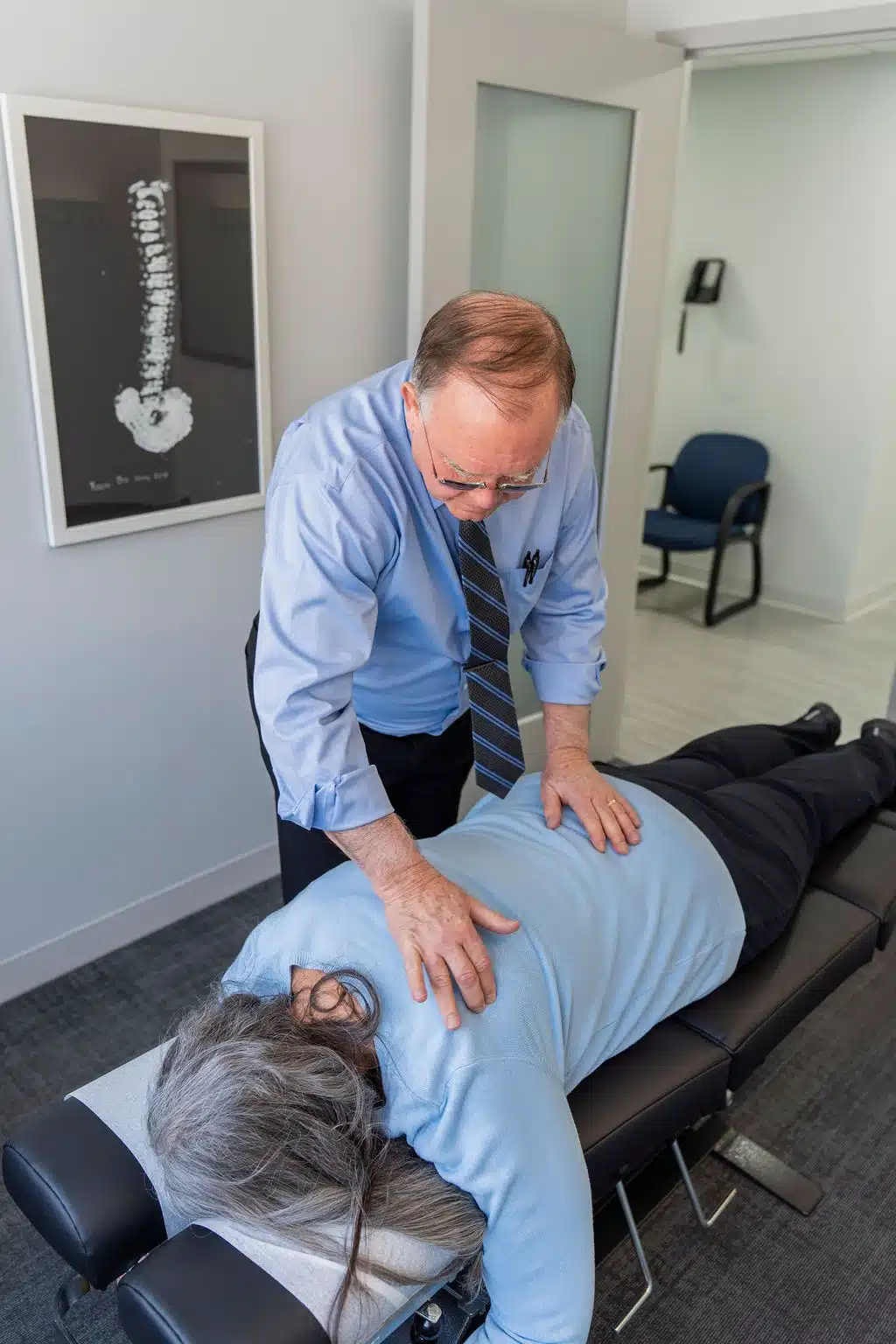 Patient positioned on a treatment table during a chiropractic back adjustment