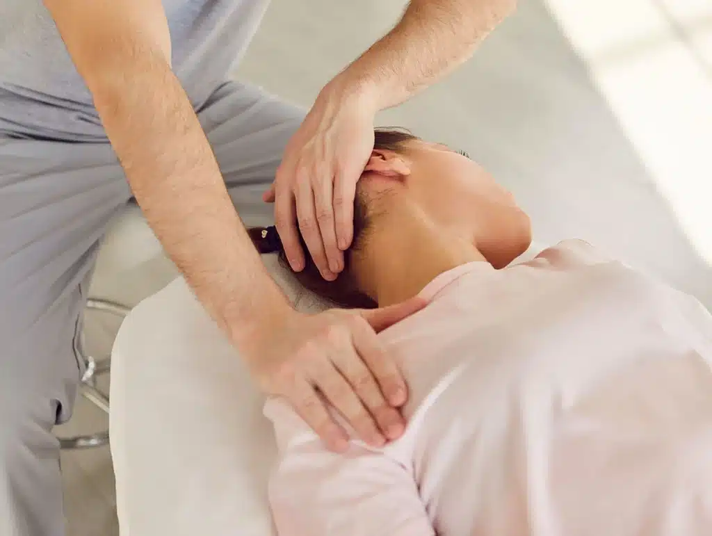 Chiropractor supporting a patient's head and neck during a cervical adjustment at ProHealth Chiropractic Rockville clinic