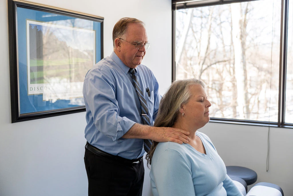 Chiropractor providing neck-focused care for a patient at ProHealth Chiropractic Rockville