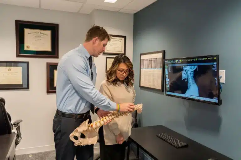 Chiropractor explaining spinal alignment to a patient at ProHealth Chiropractic in Rockville, MD